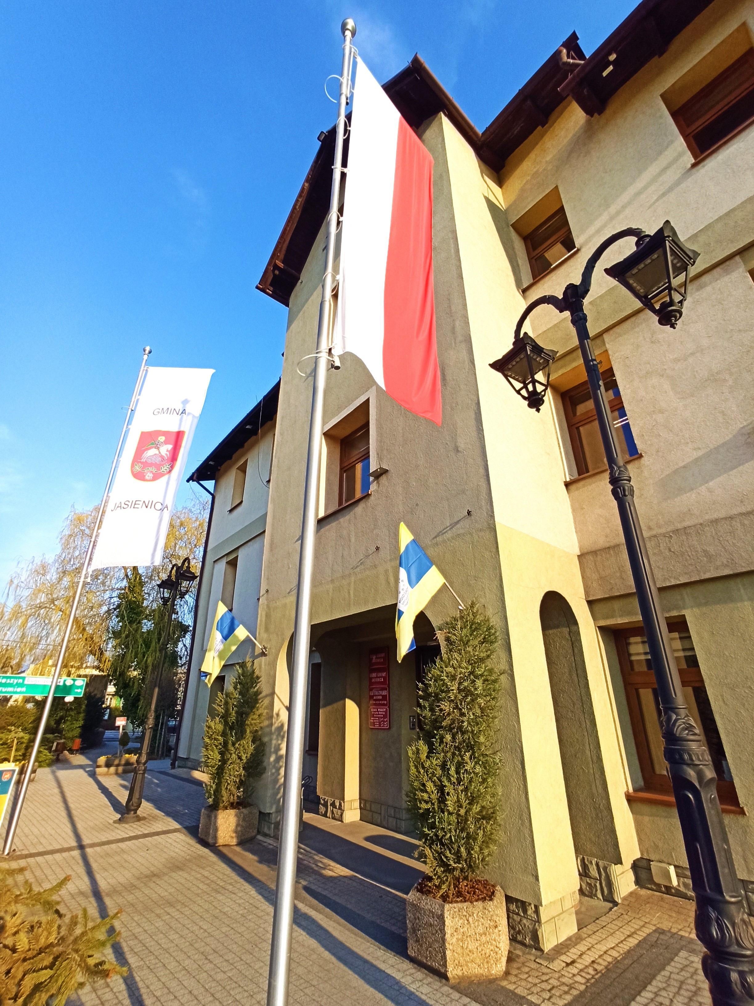 Budynek Urzędu Gminy Jasienica z flagami.